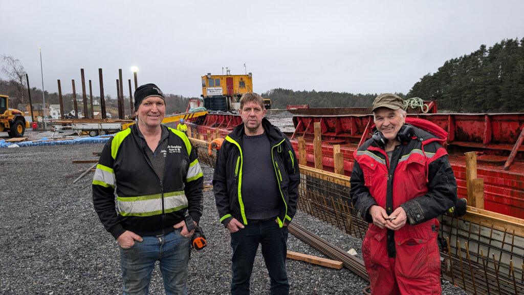 Sentrale personar ved Utbjoa Tømmerkai.
F.v. entreprenør Johs Røgelstad, Magnus Frøyland og Harald Hetland frå Vindafjord Skogeigarlag.
Til høgre ligg lekteren til Røgelstad som har vore ein viktig reiskap under arbeidet med tømmerkaien.
